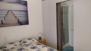 a bedroom with a bed and a picture on the wall at La Touline in La Jarne