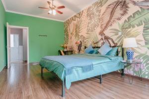 a bedroom with a bed with a tropical wallpaper at Xi'an Lianhu·Moslem Street (Huimin Jie)· Locals Apartment 00172050 in Xi'an