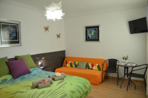 a bedroom with a bed with two teddy bears on it at SEVILLA-TRIANA in Seville