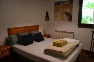 a bedroom with a bed with white sheets and pillows at Mas Franch in San Miguel de la Pineda