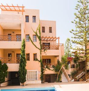 a large building with trees in front of it at Anna Maria in Malia