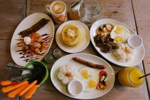a table with plates of breakfast food on it at Ted's Bed and Breakfast in Santa Cruz