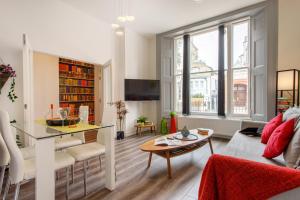 a living room with a couch and a table at Notting Hill Residences in London