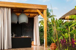 a bar at a resort with a canopy and plants at Zuri Zanzibar in Kendwa