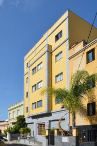 a yellow building with a dinosaur statue in front of it at Canary Lofts in Santa Cruz de Tenerife