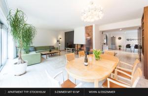 a dining room and living room with a table and chairs at HEJ Apartments Bayreuth in Bayreuth