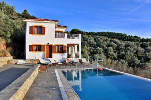 a villa with a swimming pool and a house at Villa Malena in Glossa