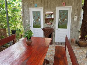 a wooden table with a potted plant on top of it at Greenhouse resort in Buriram