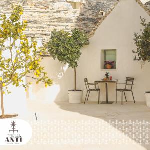 a dining room with a table and chairs at Trullo Essenza-Trulli Antì Charme & Relax in Alberobello