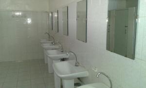 a row of sinks and mirrors in a bathroom at Auberge De Jeunesse in Rabat