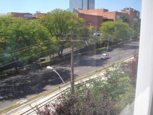 a car driving down a street in a city at Ótimo Apto Shopping Iguatemi in Porto Alegre