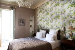 Un pat sau paturi într-o cameră la Hotel Villa Rivoli