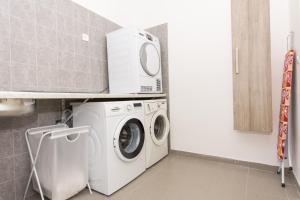 a laundry room with a washer and a microwave at Villa Piramida in Trogir +58 photos