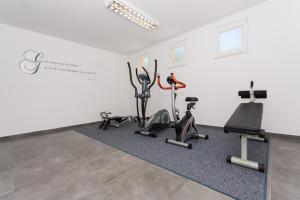 a gym with cardio equipment in a white room at Villa Piramida in Trogir