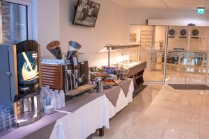 a restaurant with a counter with food on it at Stadthotel Donauwörth in Donauwörth