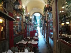 an alleyway with tables and chairs in a building at Studio Vieux Lyon in Lyon