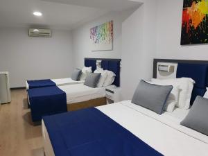 a room with two beds with blue and white at Alican 2 in İzmir