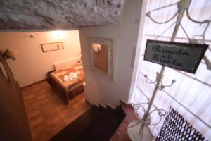 a room with a bedroom with a bed and a sign at Casa Rural La Roca in Alcalá del Júcar +2 photos