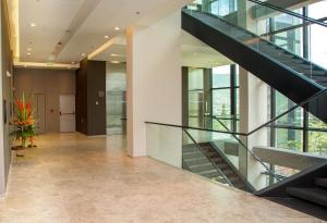 a glass staircase in a building with a hallway at Hotel Estelar Square in Medellín
