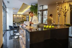 a man standing at a bar in a restaurant at Filitti Boutique Hotel in Bucharest +33 photos