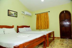a room with two beds and a window at Homestay Siolim in Siolim