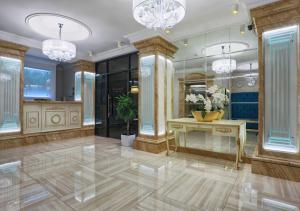 a large room with a vanity and chandeliers at FENIX TOWN in Vinnytsya