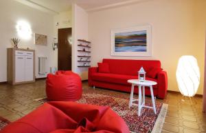 a living room with a red couch and a table at Casa del Sole in Prato