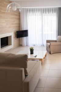 a living room with a couch and a coffee table at Niovi Boutique Apartments in Afitos
