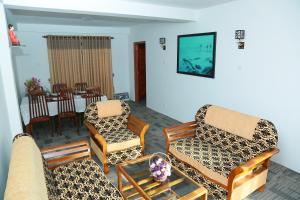 a living room with two chairs and a table at AGP home in Nuwara Eliya