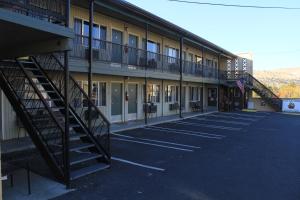 a building with a staircase in a parking lot at John Day Motel in John Day