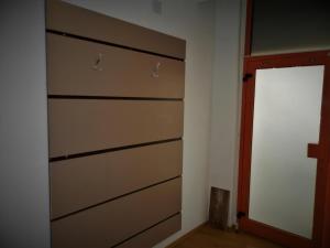 a closet with three drawers and a door in a room at Apartment Bella Vita in Zagreb