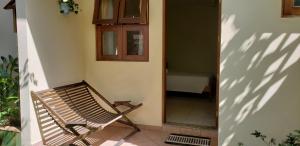 a bench sitting in the corner of a house at Suítes Jardim dos Sonhos in Ubatuba