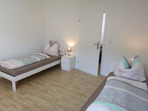 a bedroom with two beds and a lamp in it at Lüdenscheid-Ferienwohnung de Betzler Weh29-100 in Lüdenscheid