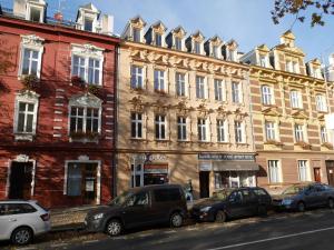 a group of cars parked in front of a building at Moskevská 40 in Karlovy Vary