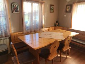 a wooden table and chairs in a dining room at Hotel Four Seasons in Samokov