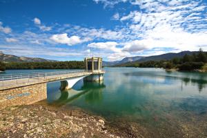 un puente sobre un cuerpo de agua con montañas en Apartahotel Al Alba, en Pozo Alcón