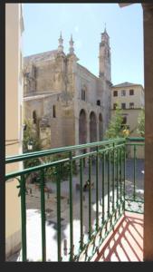 a view of an old building from a balcony at Santo Domingo Suites in Granada