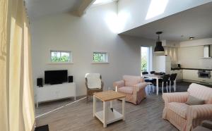 a living room with a couch and chairs and a table at Vakantiehuizen 't Centrum in Oostkapelle