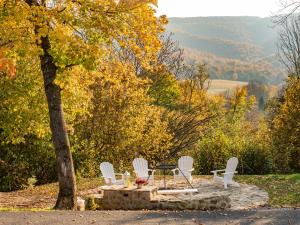 a table and chairs on a stone patio under a tree at Kraina Wetlina in Wetlina