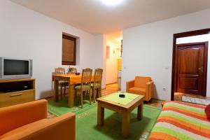 a living room with a couch and a table at Apartmani OKO Zlatibor in Zlatibor
