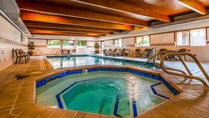 a swimming pool with a pool table and chairs in it at Best Western John Day Inn in John Day