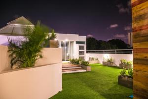 a white house with a green lawn at night at Hotel Buenos Aires in Cartagena de Indias