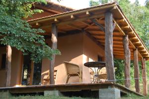 a porch of a house with a table and chairs at Chalet à Bazian in Bazian