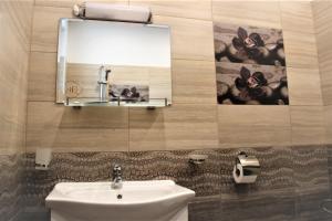 a bathroom with a sink and a mirror at Rupchini Houses in Bansko +42 photos