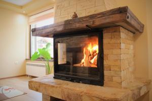a fireplace in a living room with a fire in it at Rupchini Houses in Bansko