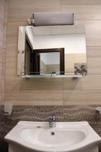 a bathroom with a sink and a mirror at Rupchini Houses in Bansko