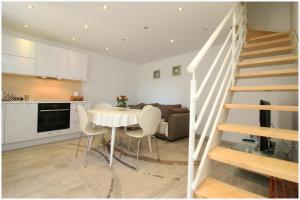 a kitchen and a living room with a table and stairs at Holiday Home Ante in Primošten