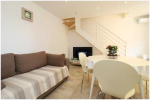 a living room with a couch and a table at Holiday Home Ante in Primošten