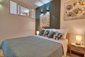 a bedroom with a large bed with two pillows at Meerblick Ferienhaus Julian nahe Rovinj in Rovinj +37 photos