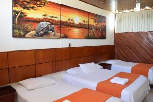 Voodi või voodid majutusasutuse Hotel Murali - Cerca del Aeropuerto de Guayaquil toas